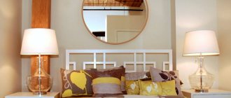 Round mirror above the head of the bed